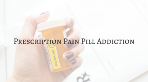 woman's hand wrapped around prescription bottle - prescription pain pill addiction