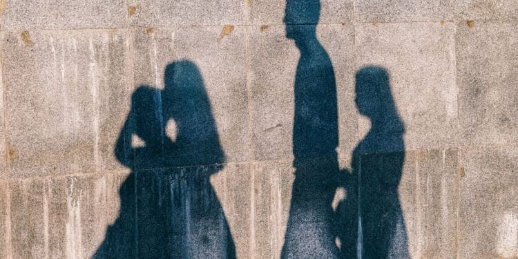 shadow of family seen on cinder block wall - alcoholism in the family