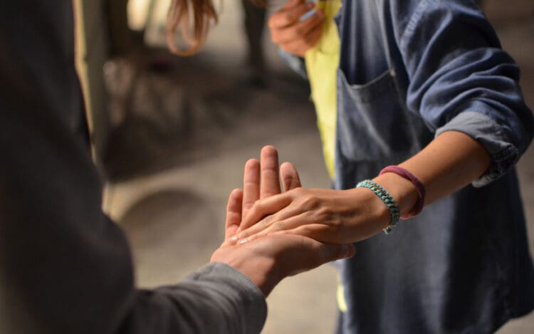 person lending hand to other person in distress - Good Samaritan Drug Overdose Act