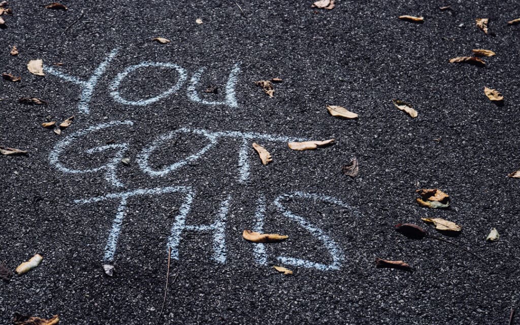 "You Got This" written in chalk on asphalt