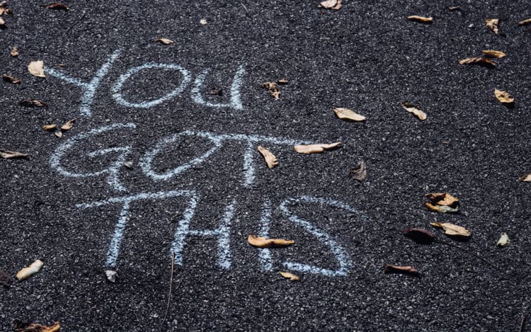 "You Got This" written in chalk on asphalt