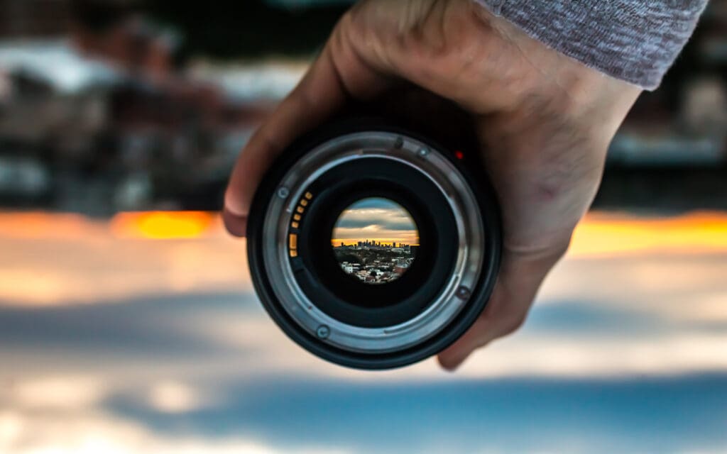 looking through lense to see reverse image of skyline
