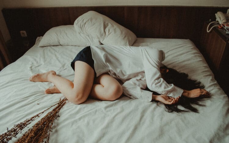 woman passed out on a bed