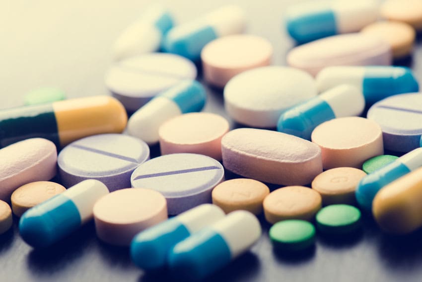 How to Help a Loved One With a Prescription Drug Problem, colorful variety of pills on pharmacy counter