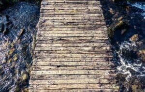 Support System in Recovery; wooden bridge over rough water
