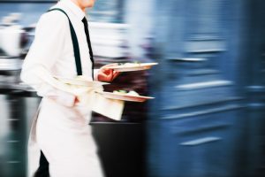 waiter carrying food - long exposure - risk