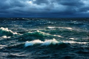 breaking ocean waves before a storm - urge surfing