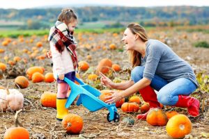 mom and little girl picking pumpkins in a pumpkin patch - substance-free ideas