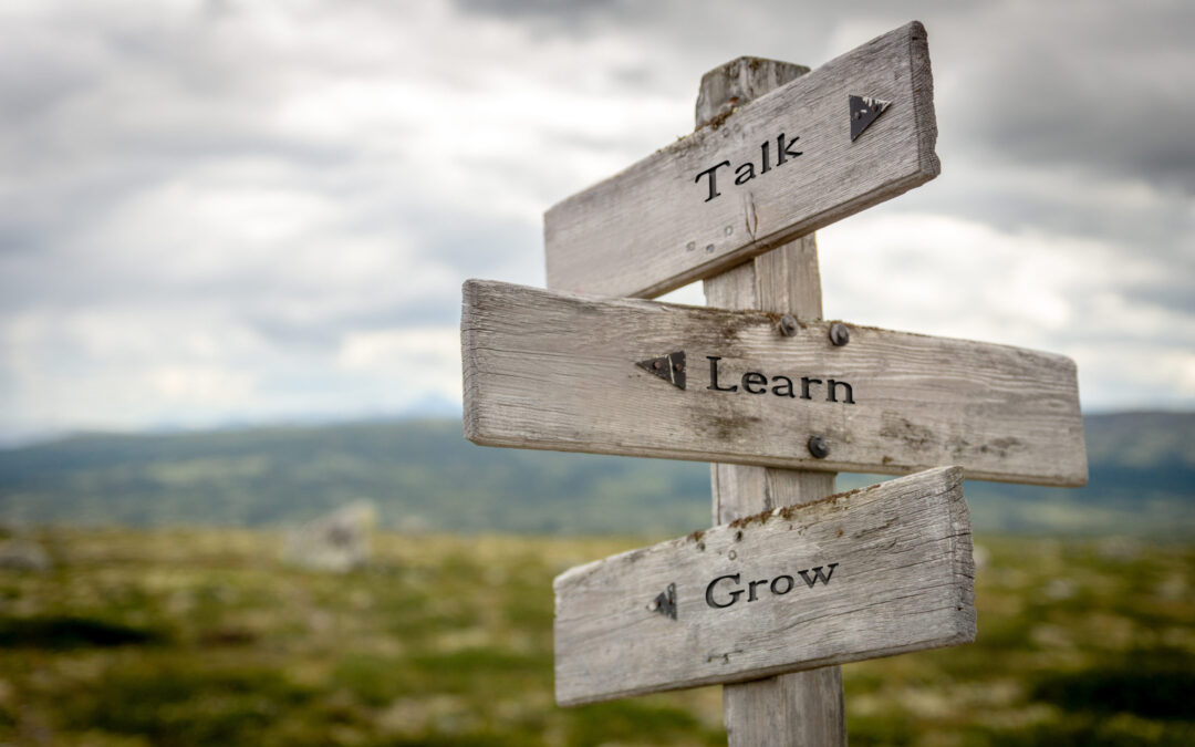 talk learn grow text on wooden signpost outdoors in nature