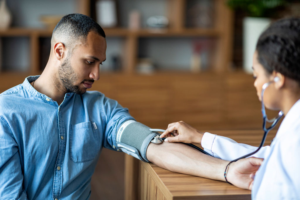 woman taking blood pressure of young man - Detox services