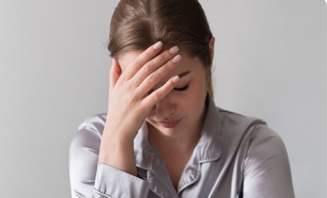 worried woman with head in hands