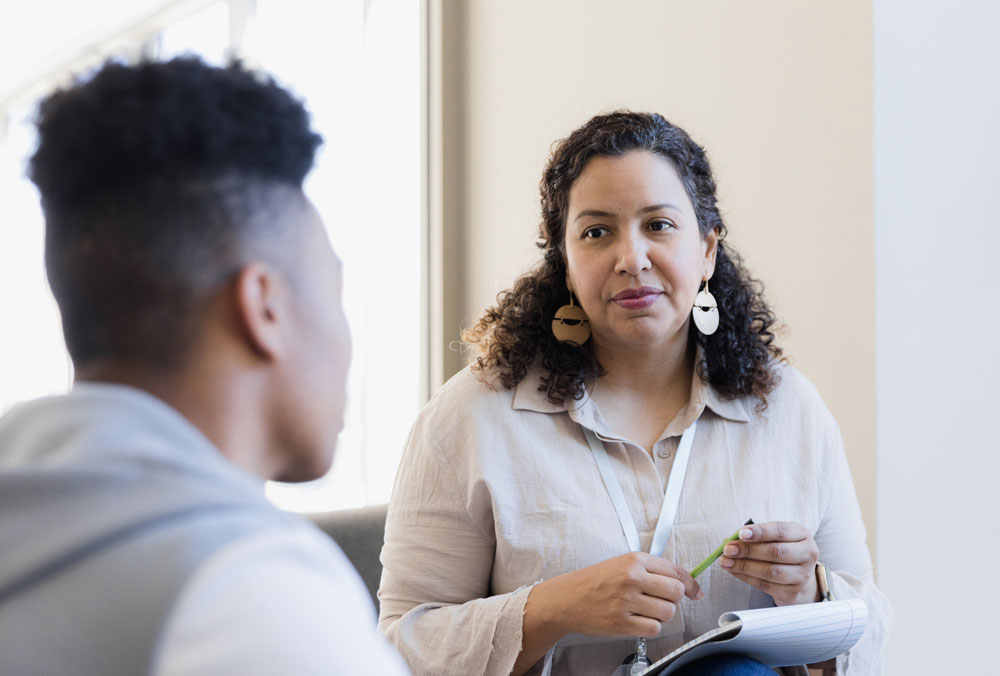 What We Treat at St. Gregory Recovery Center in Iowa , counselor talking with a client in treatment center