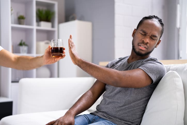 A man refusing a drink.