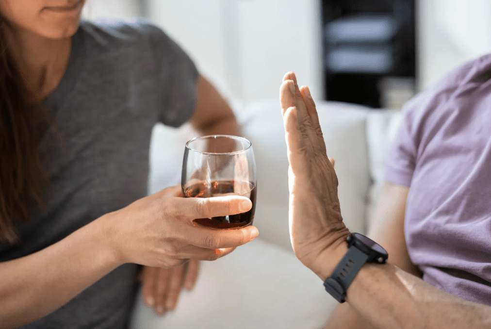 A person refusing an alcoholic drink.