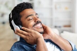 Man Enjoying Music With Headphones in Modern Living Room Setting