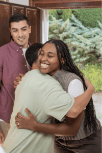 A woman hugging friends.